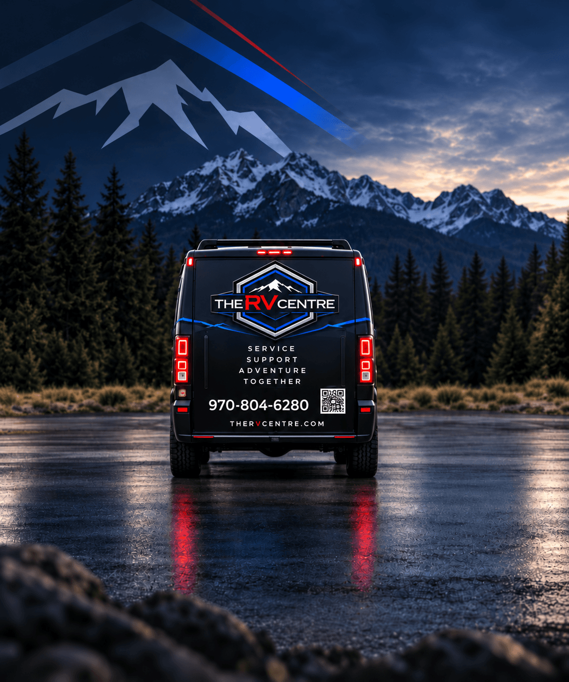 A service van branded The RV Centre, parked at dusk with mountains behind.